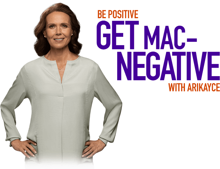A woman poses next to the campaign tagline Be Positive Get MAC-Negative with ARIKAYCE.